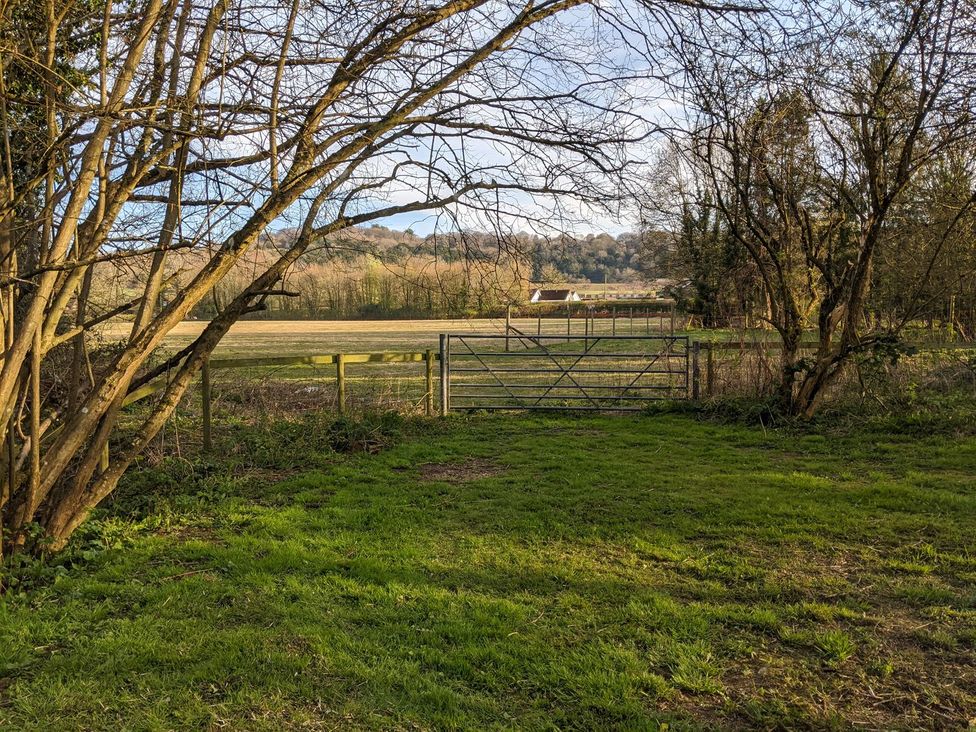 A landscape view with a gate and field at The Bullpen@Manor Farm West Tytherley