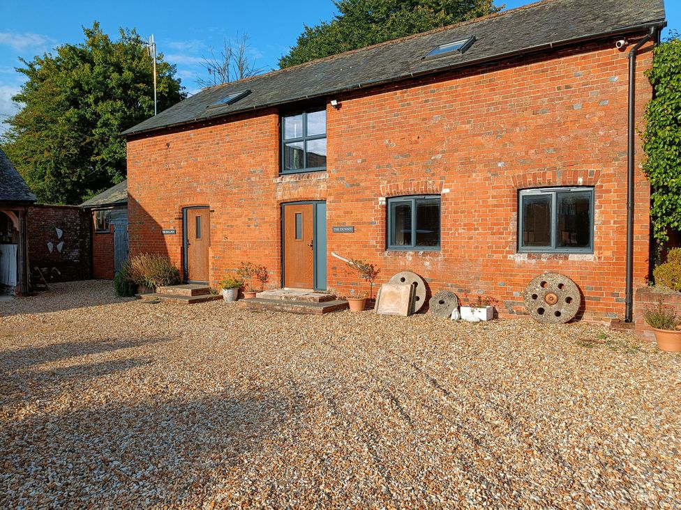 An outdoor view of a brick building with gravel at The Bullpen@Manor Farm in West Tytherley
