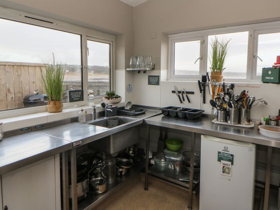 A kitchen with sink and utensils at The Boat House - Port Eynon
