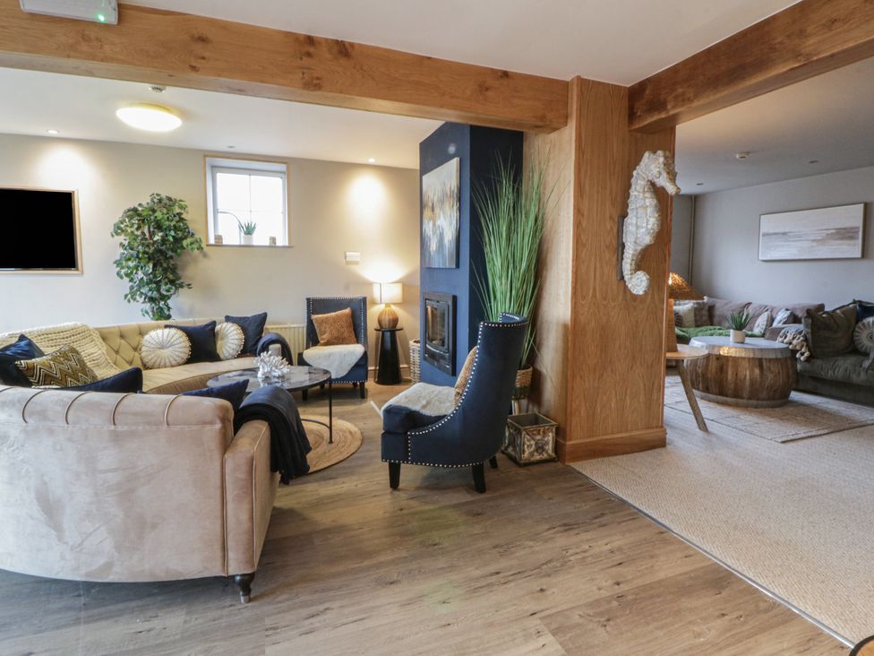 A living room with a sofa and coffee table at The Boat House - Port Eynon