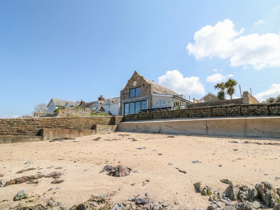 A beach with a house in the background at The Boat House - Port Eynon