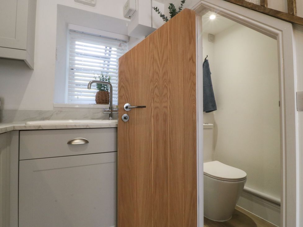 A bathroom with a toilet and sink at 61A High Street in Criccieth
