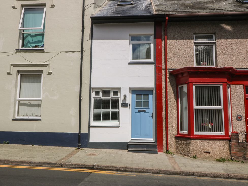 A building with a blue door and windows at 61A High Street Criccieth