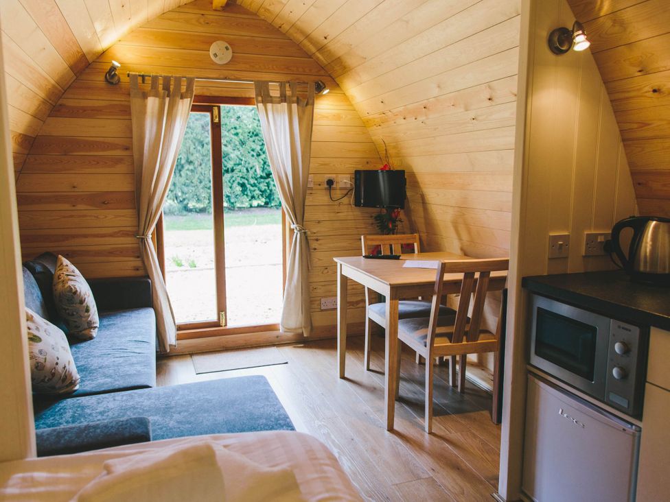 A living room with a table and chairs at Garden Pod in Waltham
