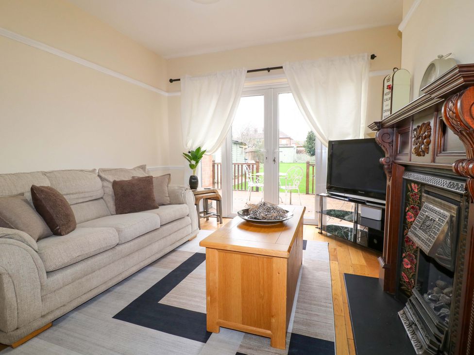 A living room with a sofa and television at 5 Wallace Road in Loughborough