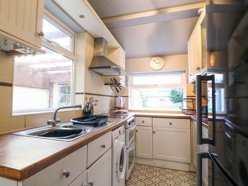 A kitchen with appliances and countertops at 5 Wallace Road in Loughborough