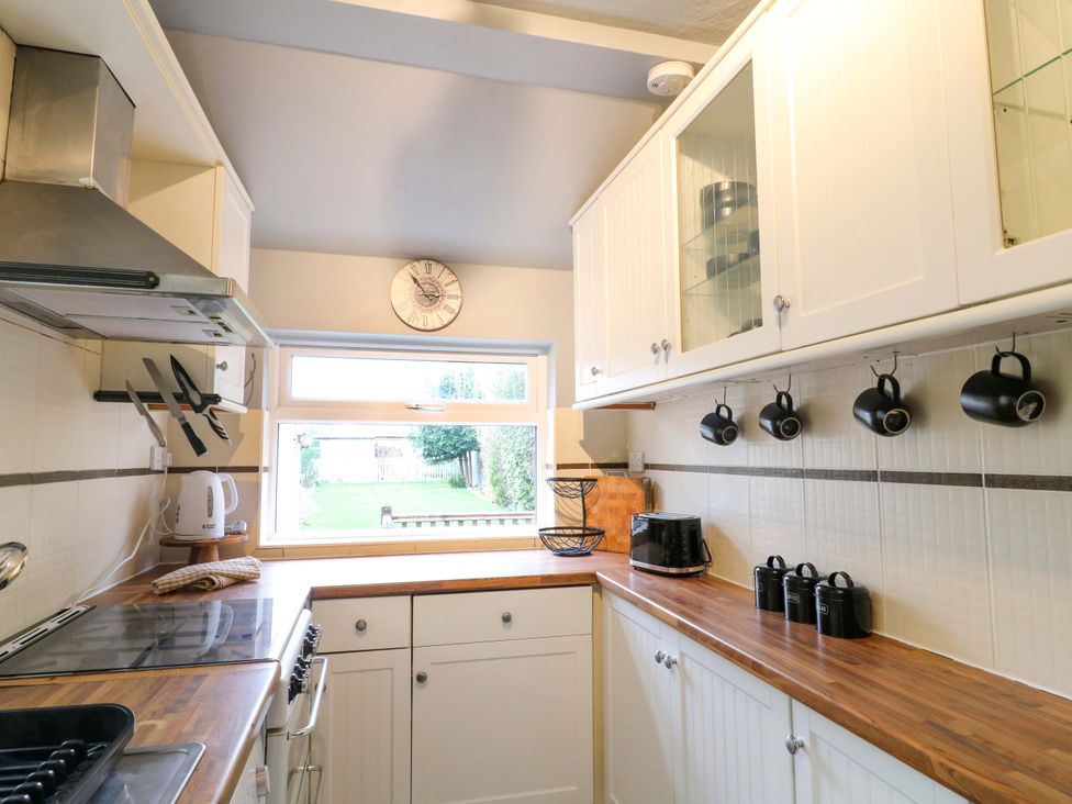 A kitchen with a window, kettle, and countertop at 5 Wallace Road in Loughborough