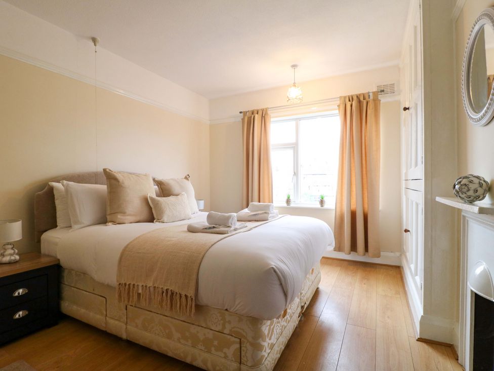 A bedroom with a bed and curtains at 5 Wallace Road in Loughborough