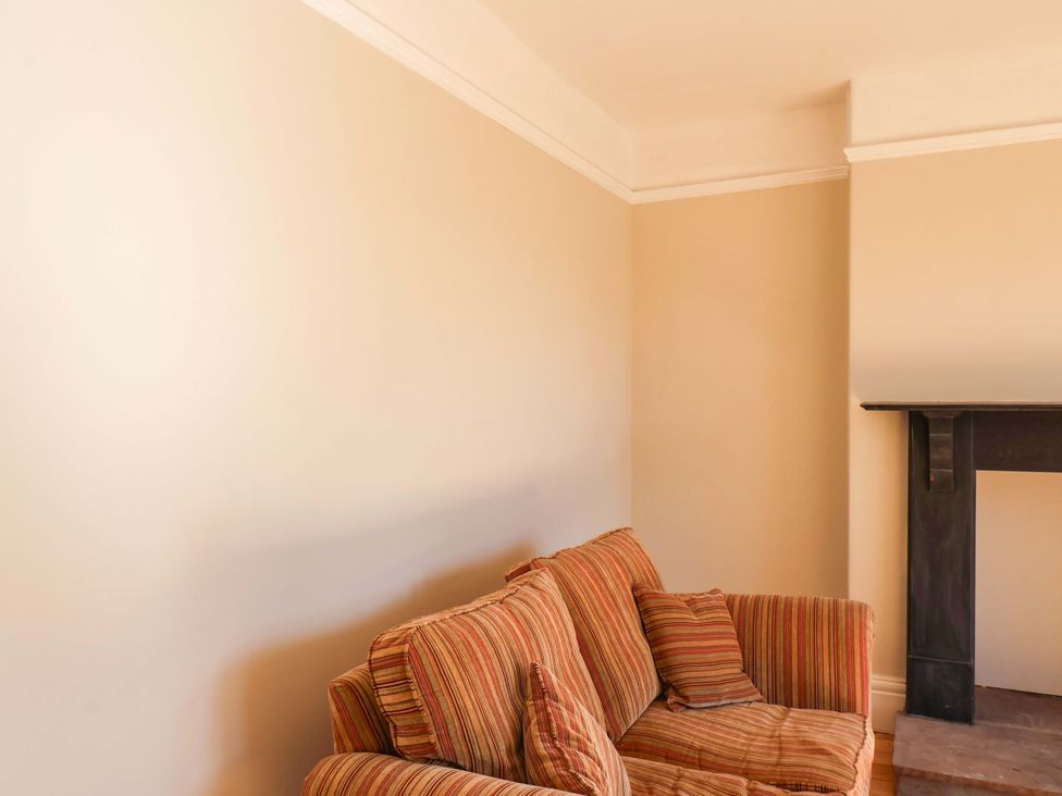 A living room with a sofa and a fireplace at 22 The Lane Saltburn-by-the-Sea