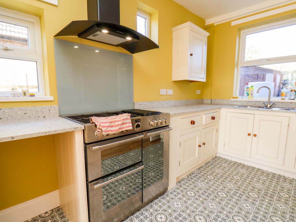 A kitchen with a stove and sink at 22 The Lane Saltburn-by-the-Sea