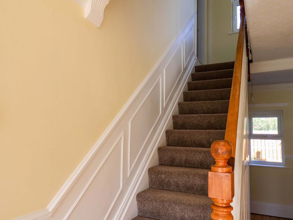 A staircase leading to a door in a hallway at 22 The Lane Saltburn-by-the-Sea