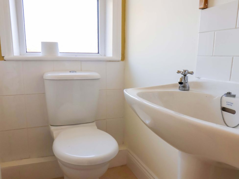 A bathroom with a toilet and sink at 22 The Lane in Saltburn-by-the-Sea