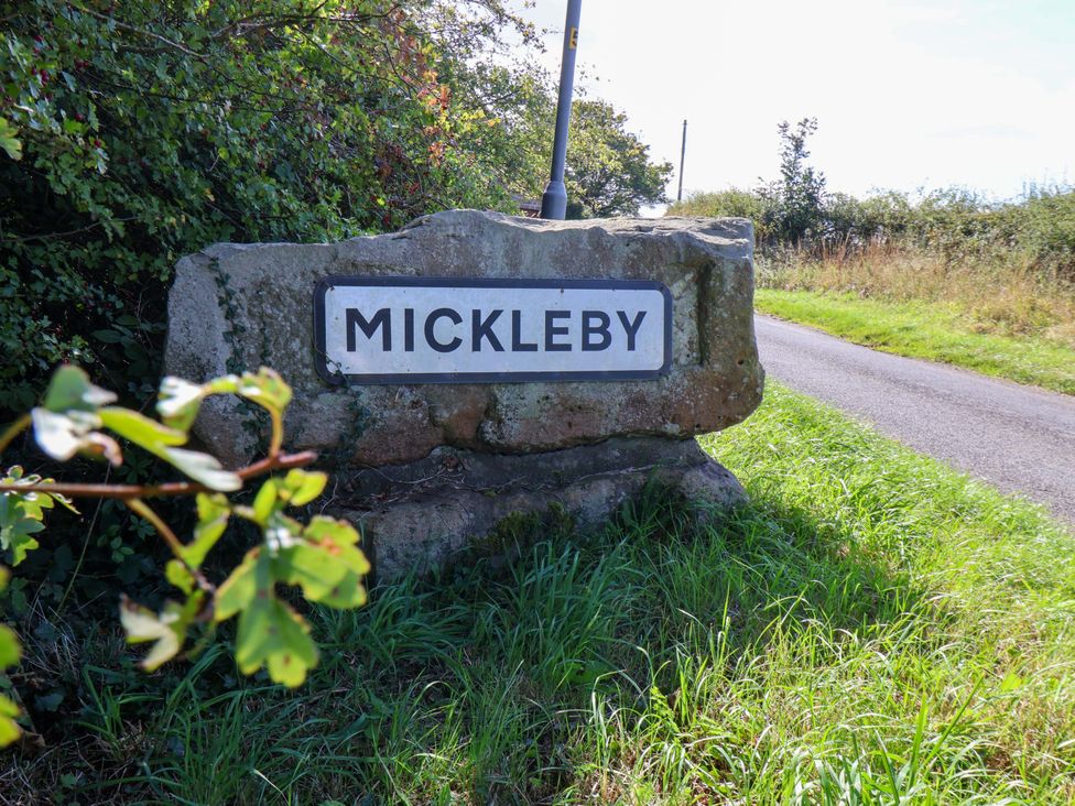 A sign marking Mickleby at the roadside