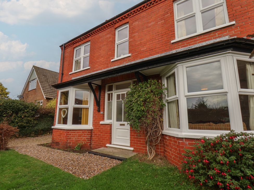 A house with windows and a doorway surrounded by plants at The Manse in Whitby
