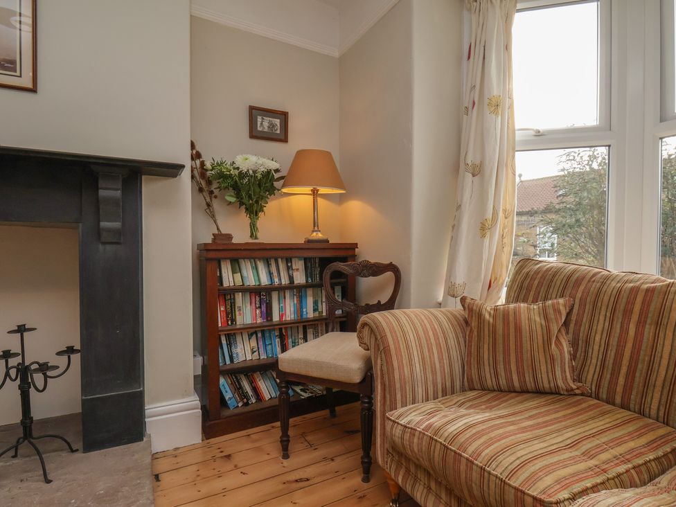 A living room with a bookshelf and a sofa at The Manse in Whitby