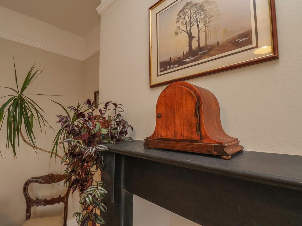 A living room with a wooden box and plants at The Manse in Whitby