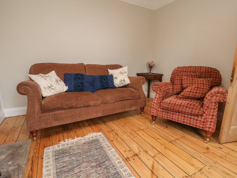 A living room with a sofa and armchair at The Manse in Whitby