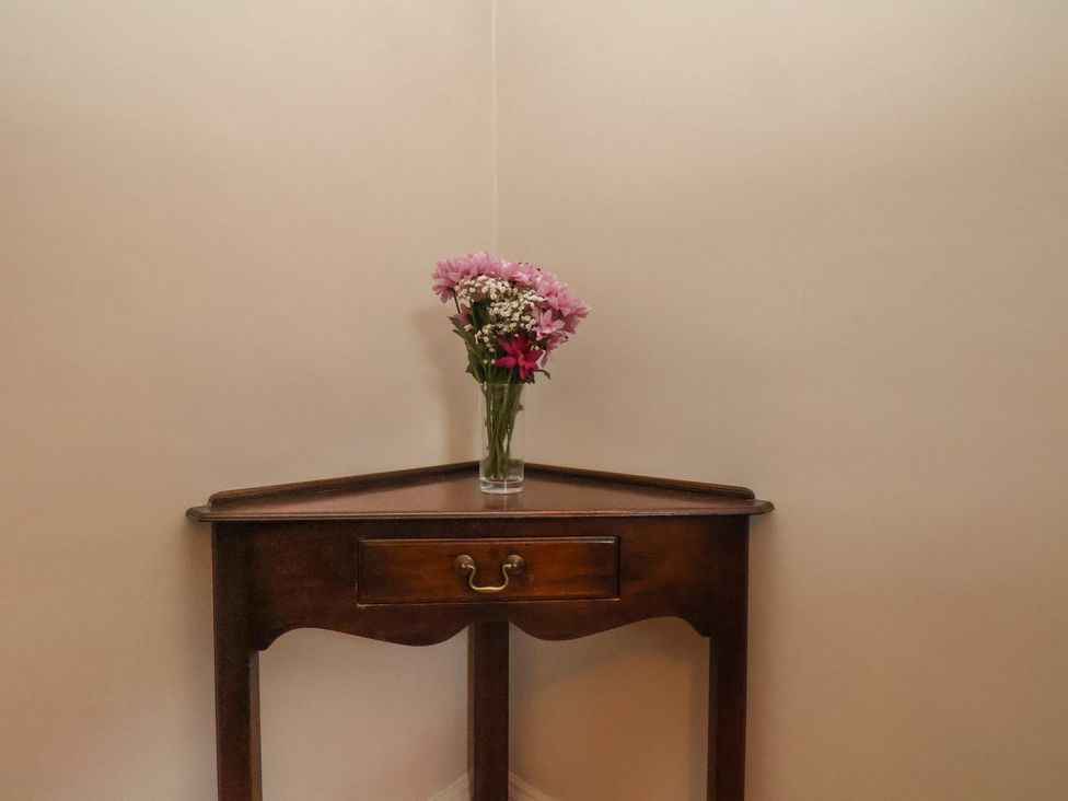 A table with flowers in a vase at The Manse in Whitby