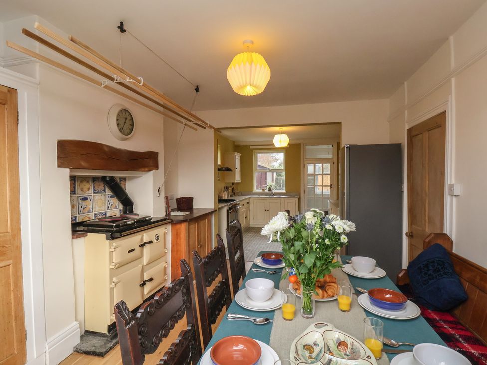 A kitchen with a dining table set for breakfast at The Manse in Whitby