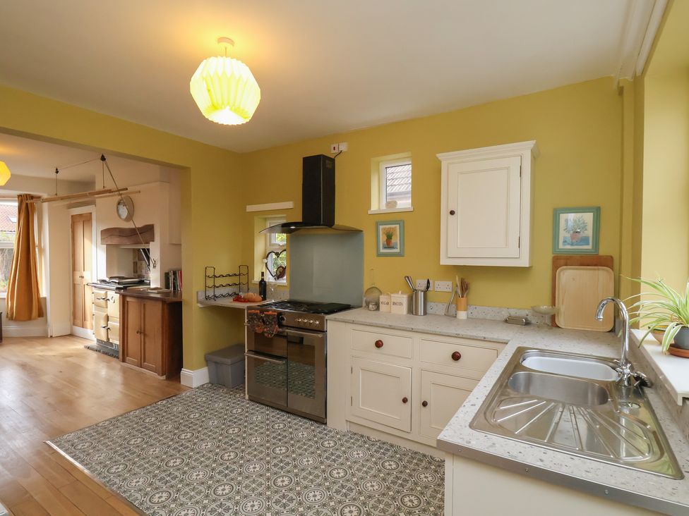A kitchen with an oven and sink at The Manse in Whitby