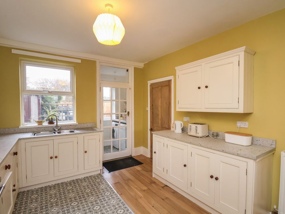 A kitchen with cabinets and appliances at The Manse in Whitby