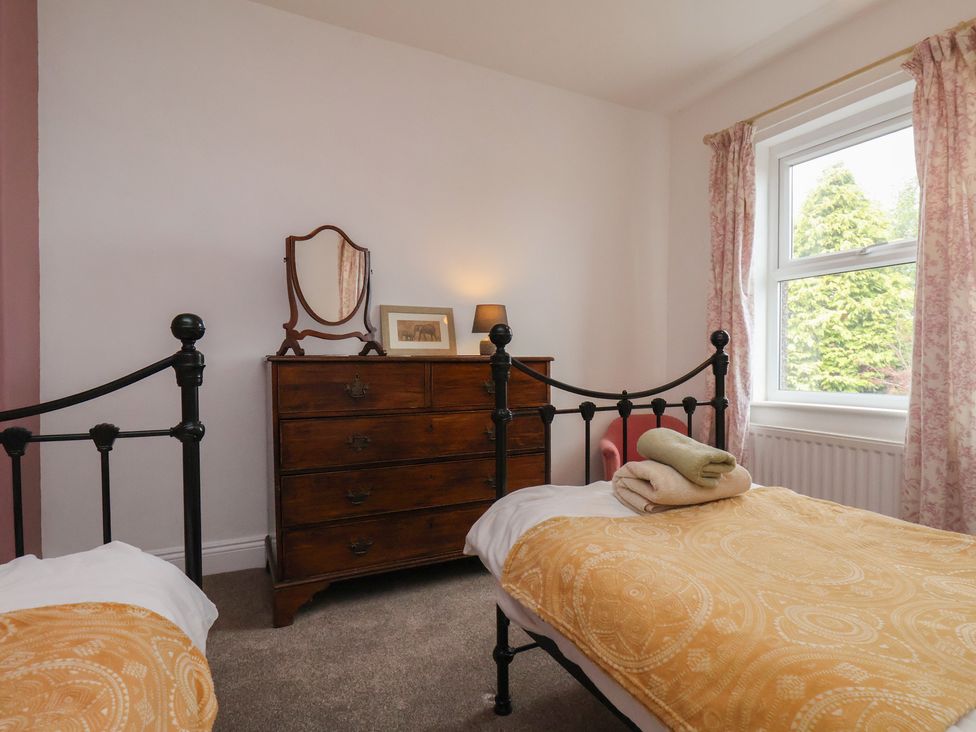 A bedroom with two beds and a wooden dresser at The Manse in Whitby