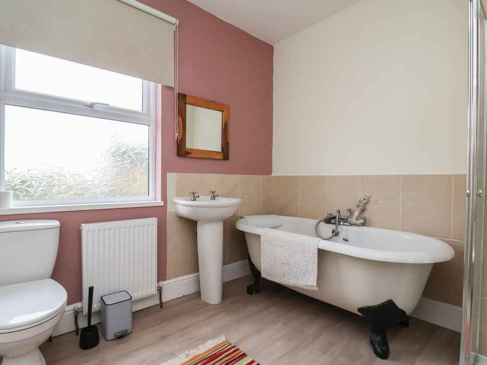 A bathroom with a bathtub and sink at The Manse in Whitby