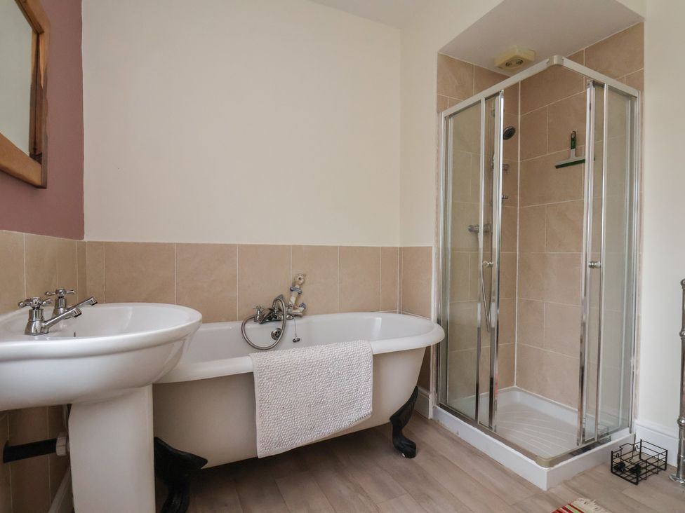 A bathroom with a bath tub and shower at The Manse in Whitby