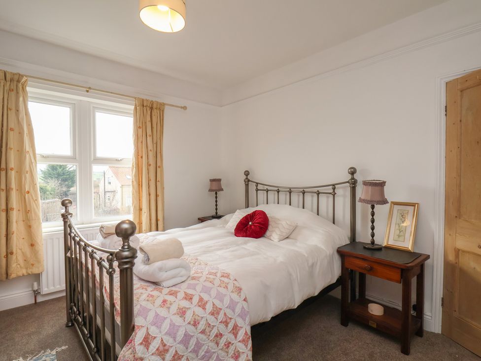 A bedroom with a bed and bedside table at The Manse in Whitby