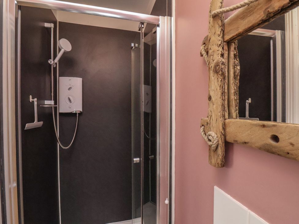 A shower area with a mirror at The Manse in Whitby