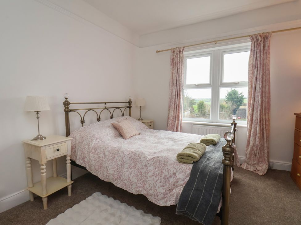A bedroom with a bed and bedside table at The Manse in Whitby