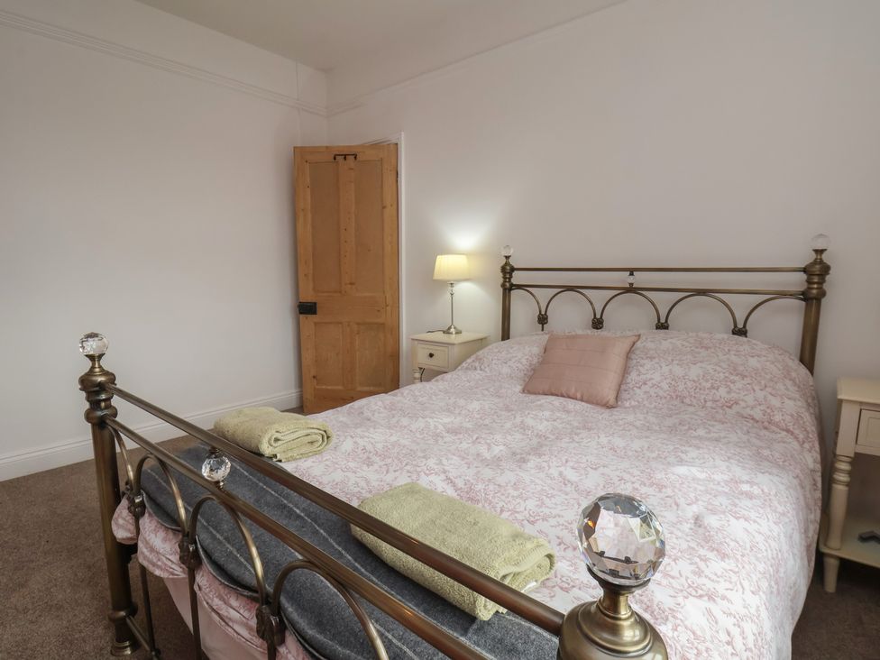 A bedroom with a bed and a lamp at The Manse in Whitby