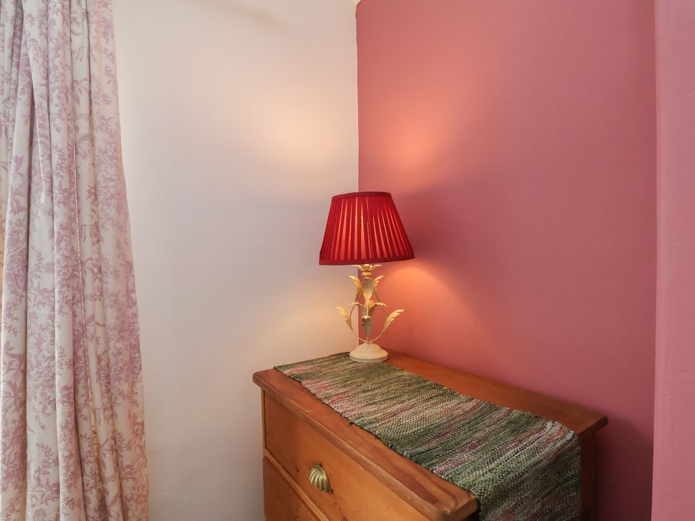A lamp on a dresser in a bedroom at The Manse in Whitby