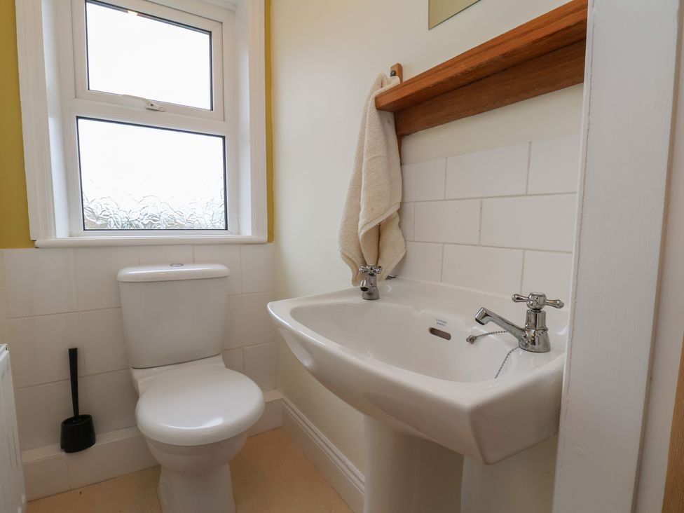 A bathroom with a toilet and sink at The Manse in Whitby
