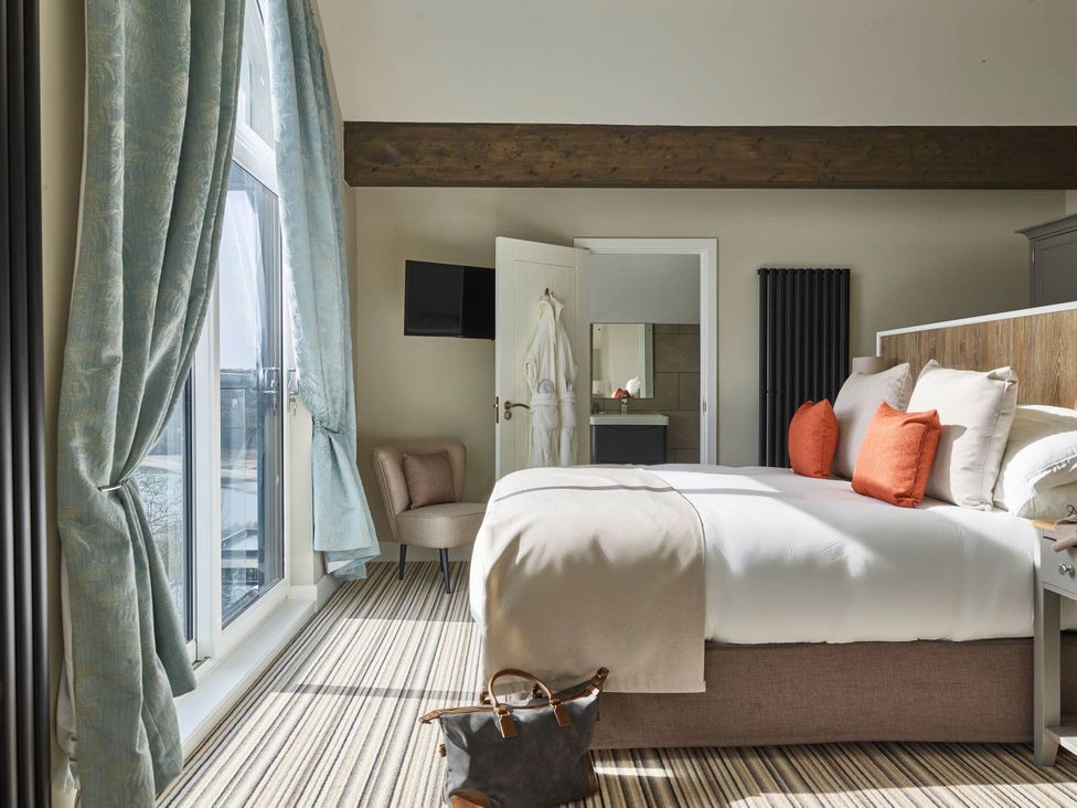 A bedroom with a bed and a window at Ferry Hills in Laugharne