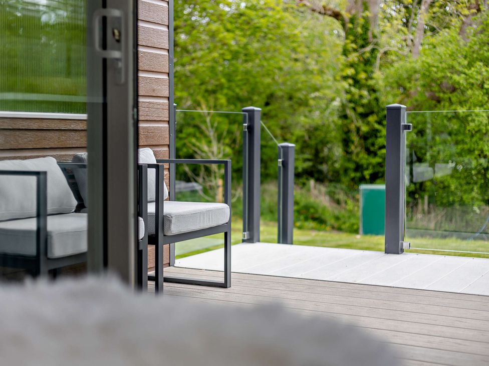 A seating area with chairs and cushions at Prion Spa Llandyrnog