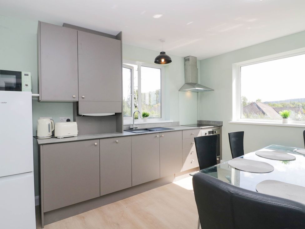 A kitchen with appliances and a dining table at Aqueduct Residence in Lancaster