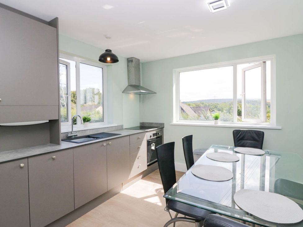A kitchen with cabinets and a dining table at Aqueduct Residence in Lancaster