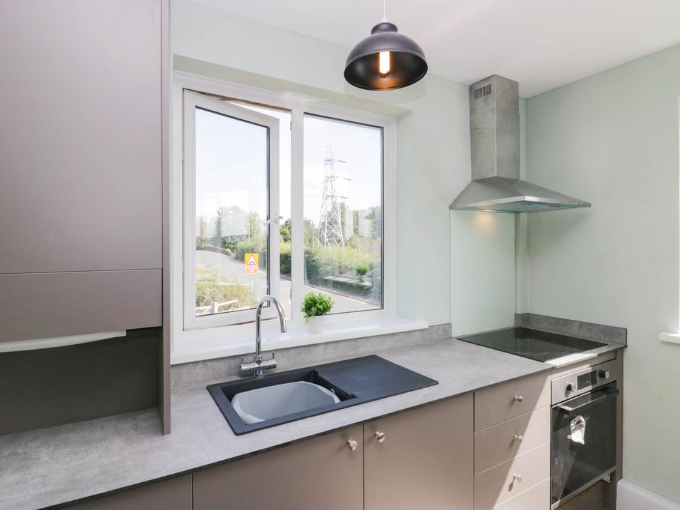 A kitchen with a sink and stovetop at Aqueduct Residence in Lancaster