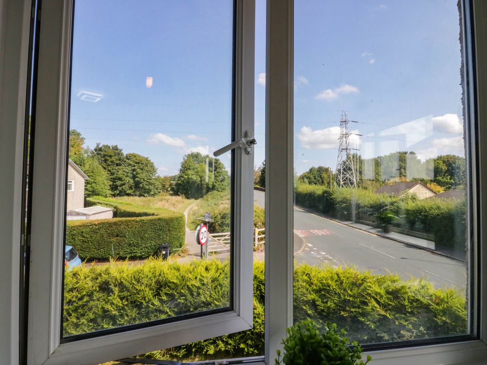 A view from a window showing a hedge and a road at Aqueduct Residence in Lancaster