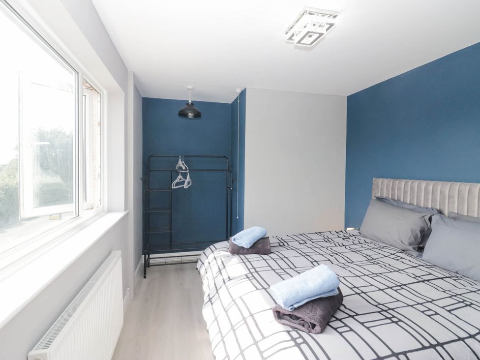 A bedroom with a bed and a clothes rack at Aqueduct Residence in Lancaster