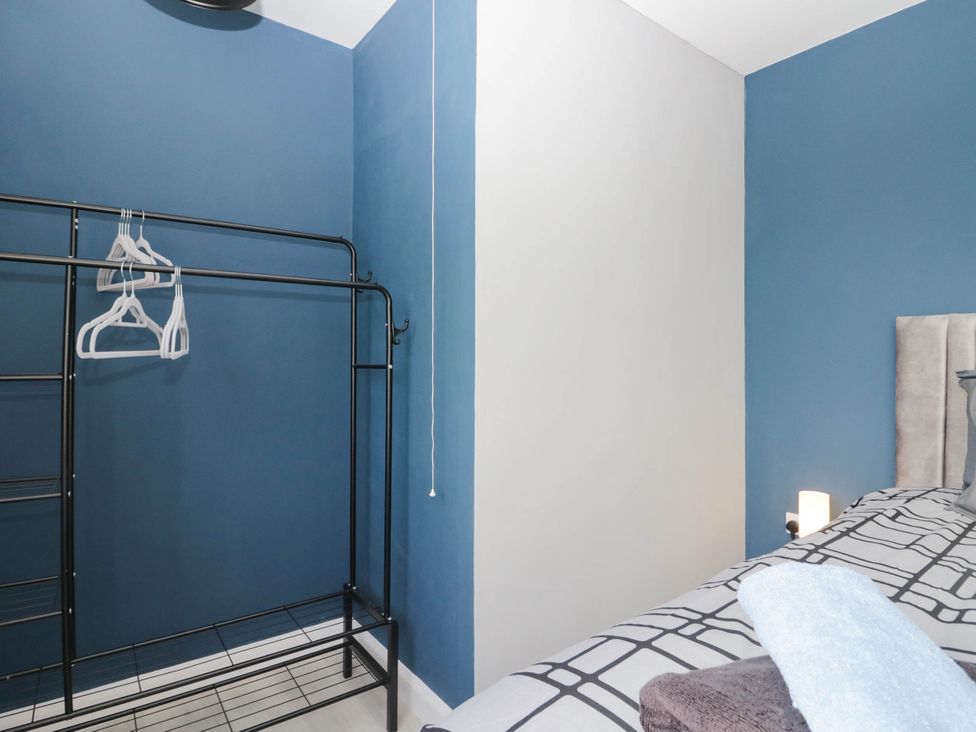 A bedroom with a clothes rack and towels at Aqueduct Residence Lancaster