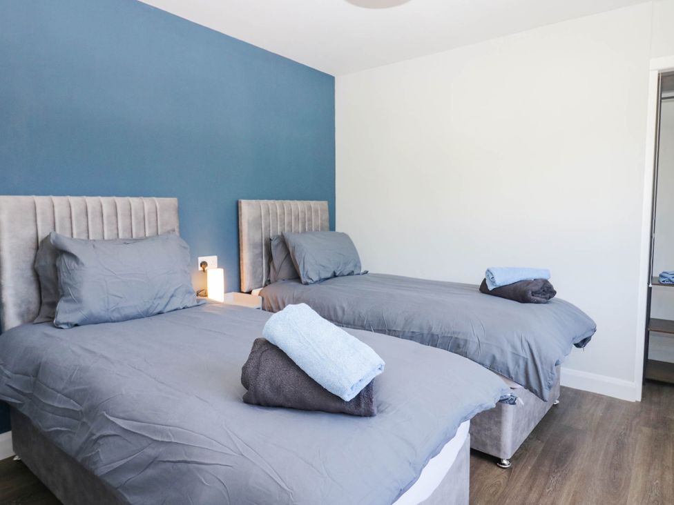 A bedroom with two single beds and a nightstand at Aqueduct Residence in Lancaster