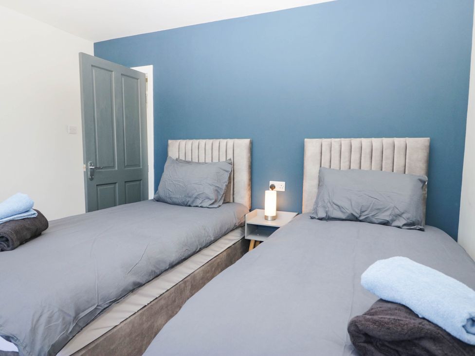 A bedroom with two beds and a bedside table at Aqueduct Residence in Lancaster
