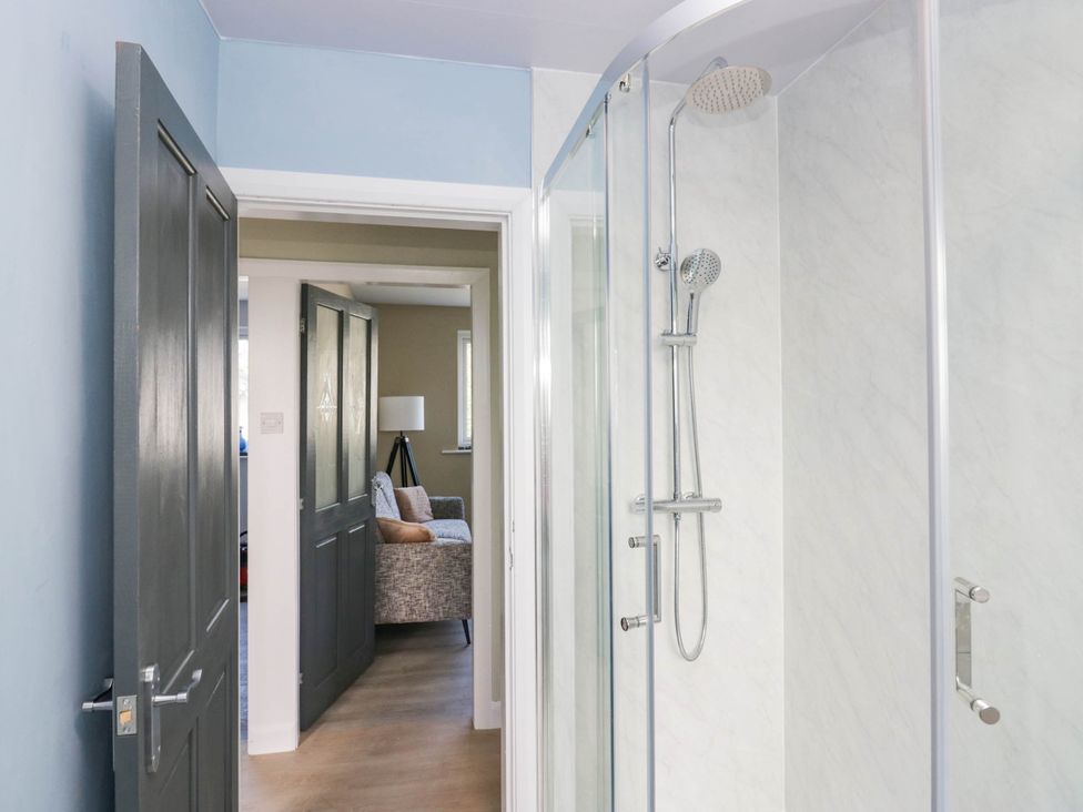 A bathroom with a shower and door leading to another room at Aqueduct Residence in Lancaster