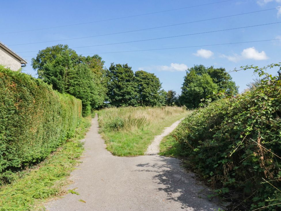 A pathway splitting into two directions with trees and grass at Aqueduct Residence in Lancaster