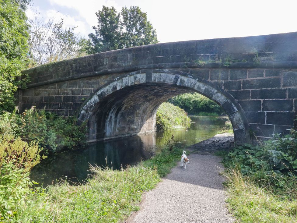 A bridge over water with a dog near a path at Aqueduct Residence Lancaster