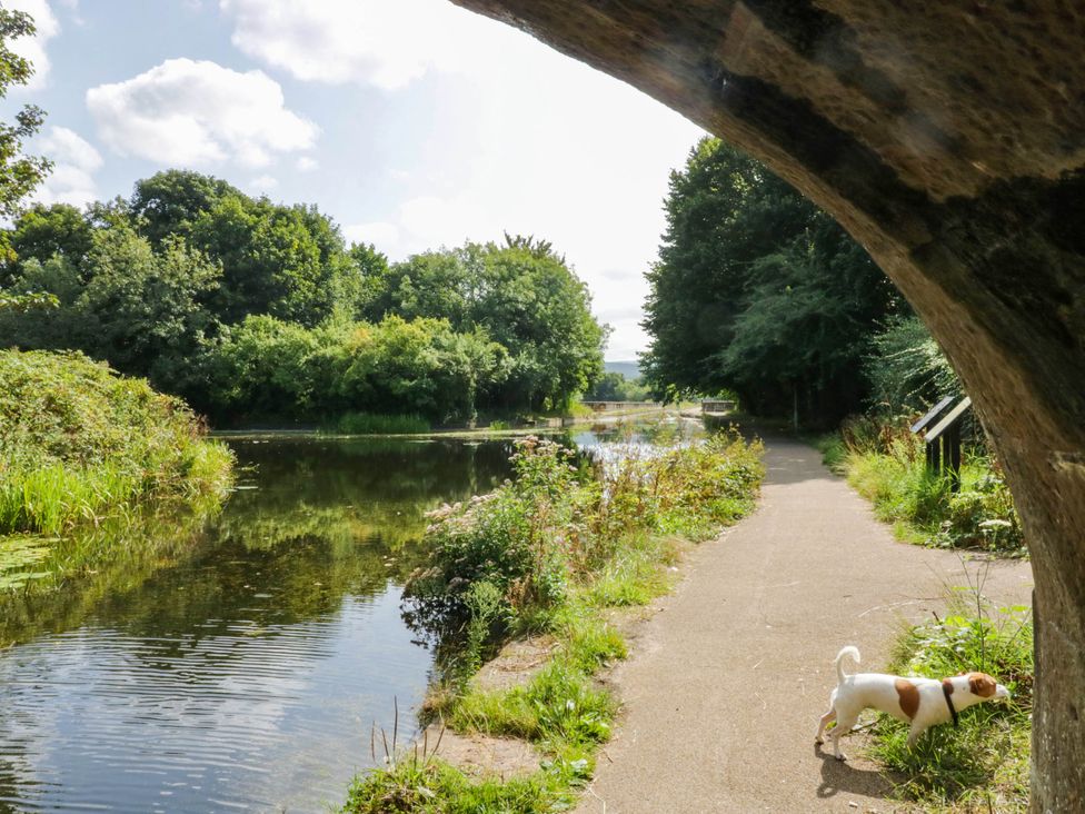 A path beside water with a dog at Aqueduct Residence in Lancaster