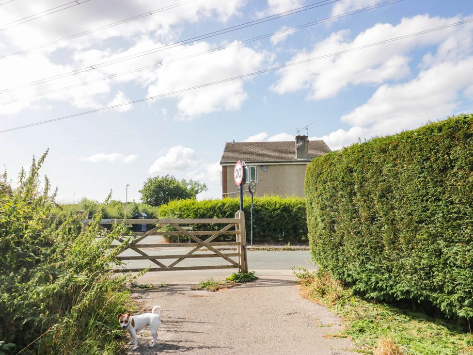An outdoor area with a dog near a gate and a house at Aqueduct Residence in Lancaster