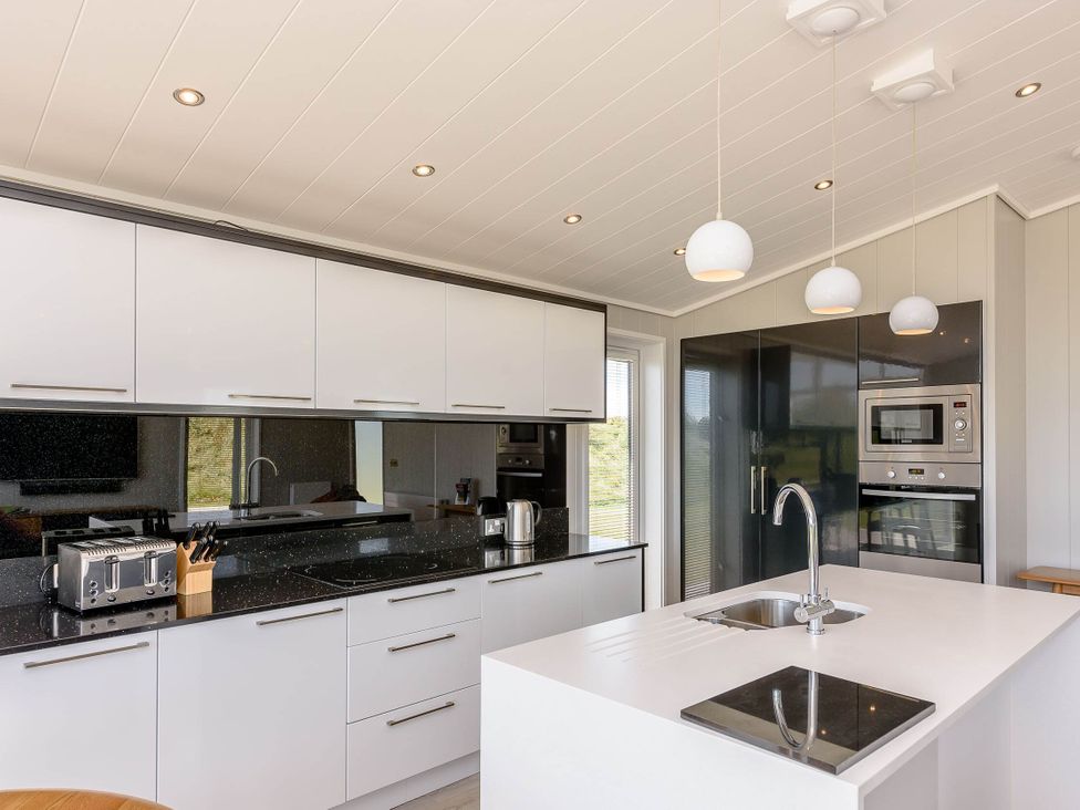 A kitchen with a sink and appliances at Darwin Retreat in Wigton
